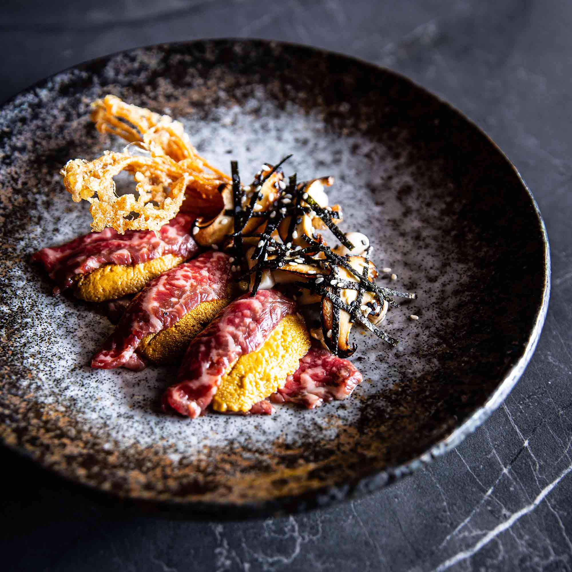 Wagyu Carpaccio with Sea Urchin, Sauteed, Pickled & Fried Mushrooms, Nori & Sesame